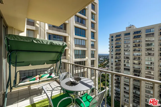 a balcony view with couple of chairs