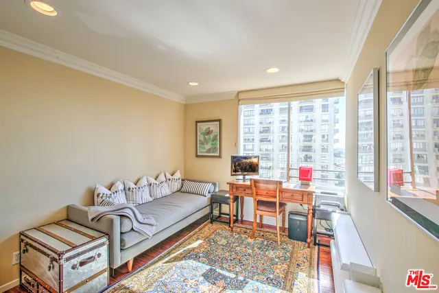 a living room with furniture and a floor to ceiling window
