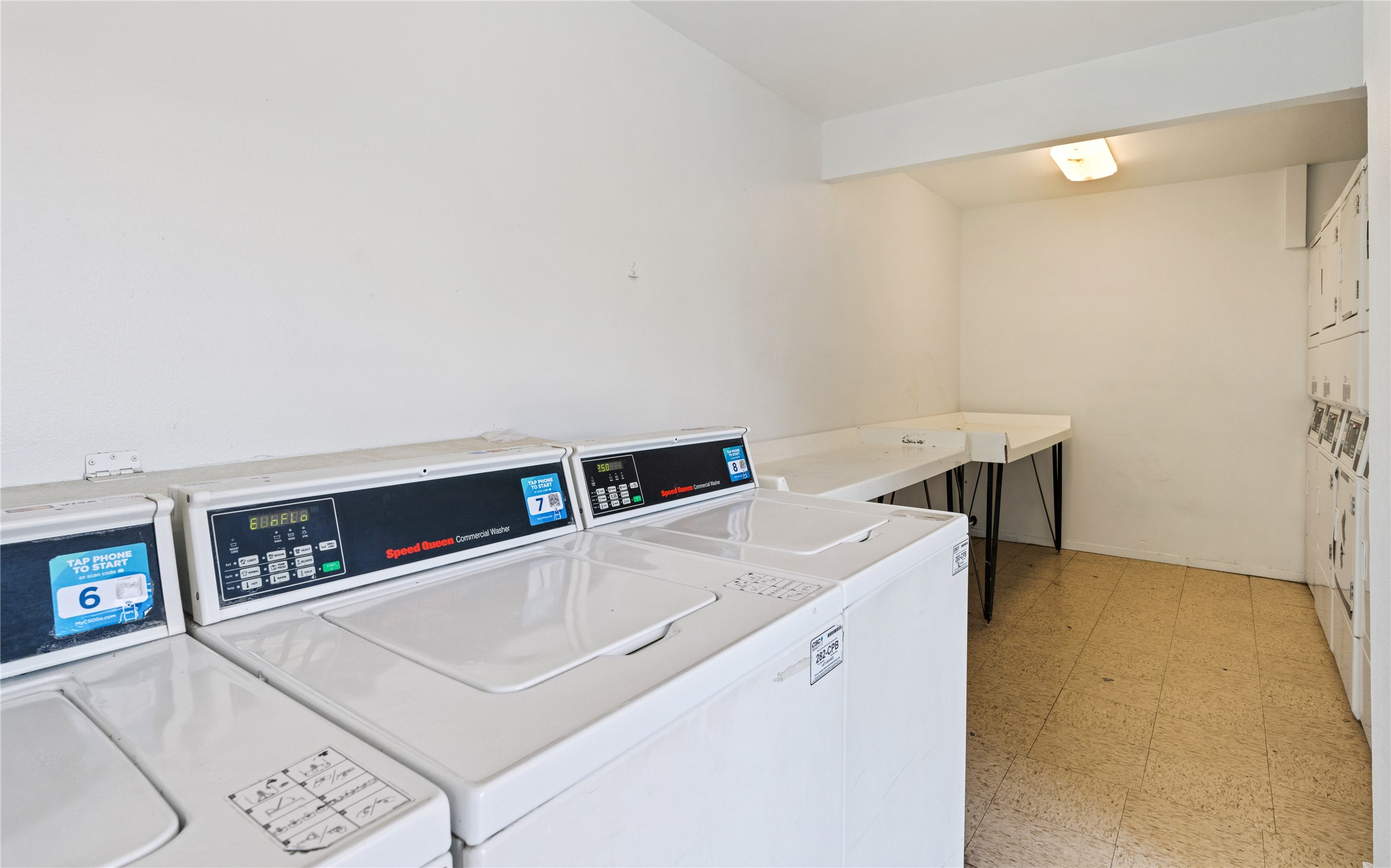 2124 Burton Drive, Unit 159 Austin, TX 78741 - Photo 19 of 23 A well-maintained common laundry area featuring multiple commercial washing machines.