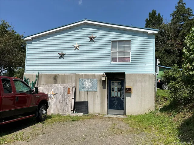 a view of backyard with car parked