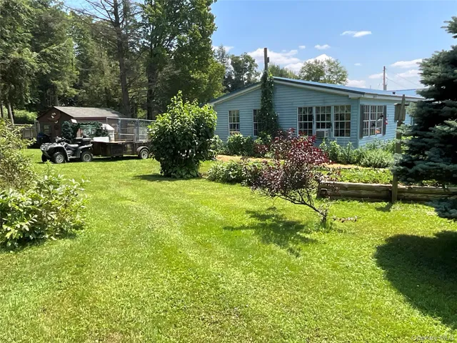 a car parked in front of a house and a yard