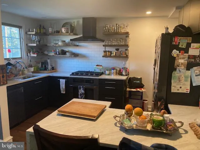 a kitchen with stainless steel appliances granite countertop a sink dishwasher and a stove with white countertops