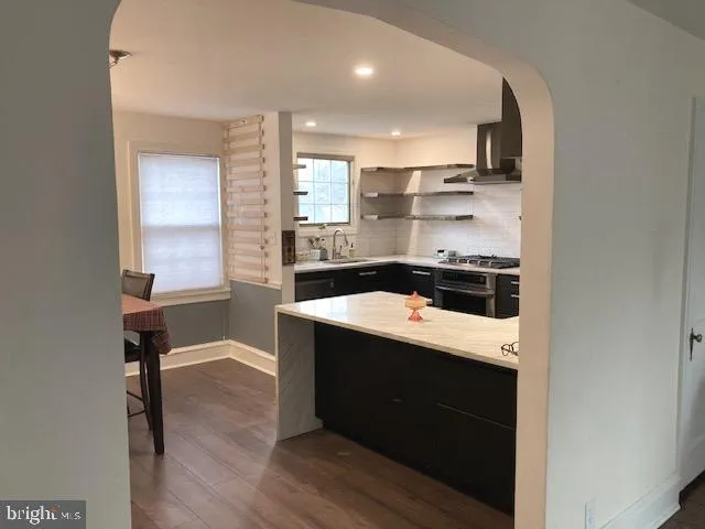 a kitchen with a stove and a refrigerator