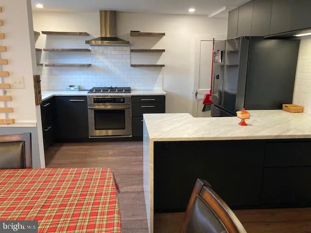 a kitchen with stainless steel appliances a stove and a refrigerator
