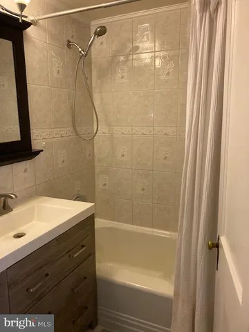 a bathroom with a shower and a sink