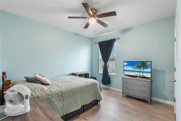 a bedroom with a bed and a chandelier