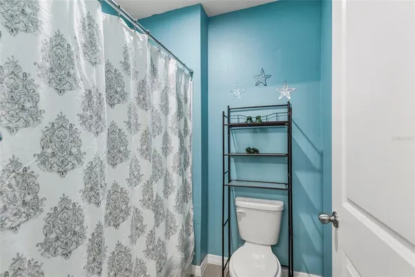 a bathroom with a toilet and a shower
