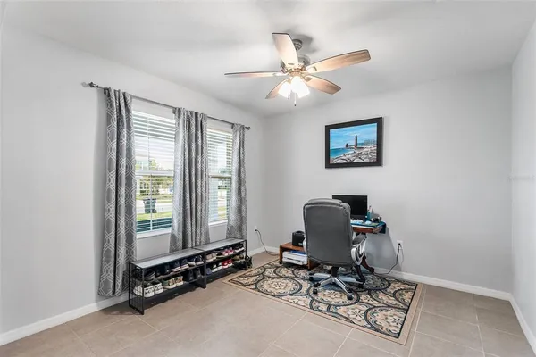 a view of a workspace with furniture and a window