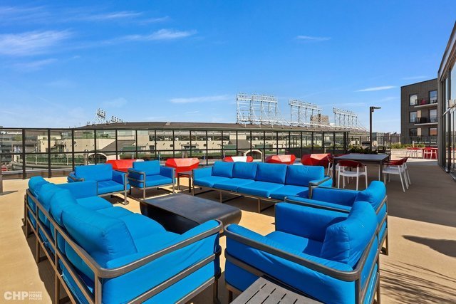 1025 West Addison Street, Unit 722 Chicago, IL 60613 - Photo 6 of 15 a view of a rooftop deck with couch and chairs