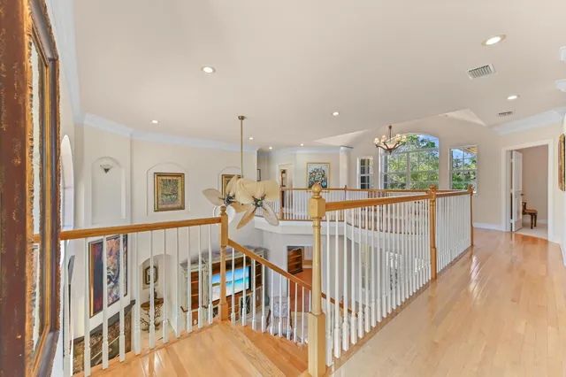 a spacious bedroom with a bed and large windows