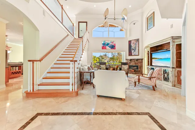 a kitchen with granite countertop a stove a sink a dining table and chairs