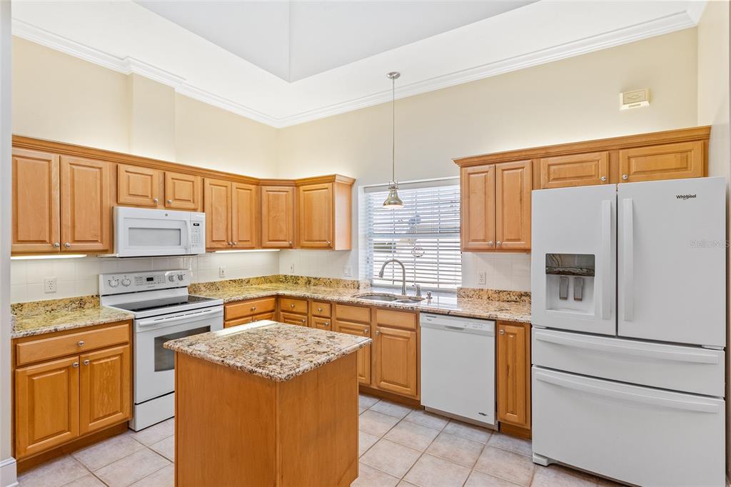 10526 Northwest 32nd Road Gainesville, FL 32606 - Photo 14 of 48 a kitchen with stainless steel appliances granite countertop a stove a sink and a refrigerator