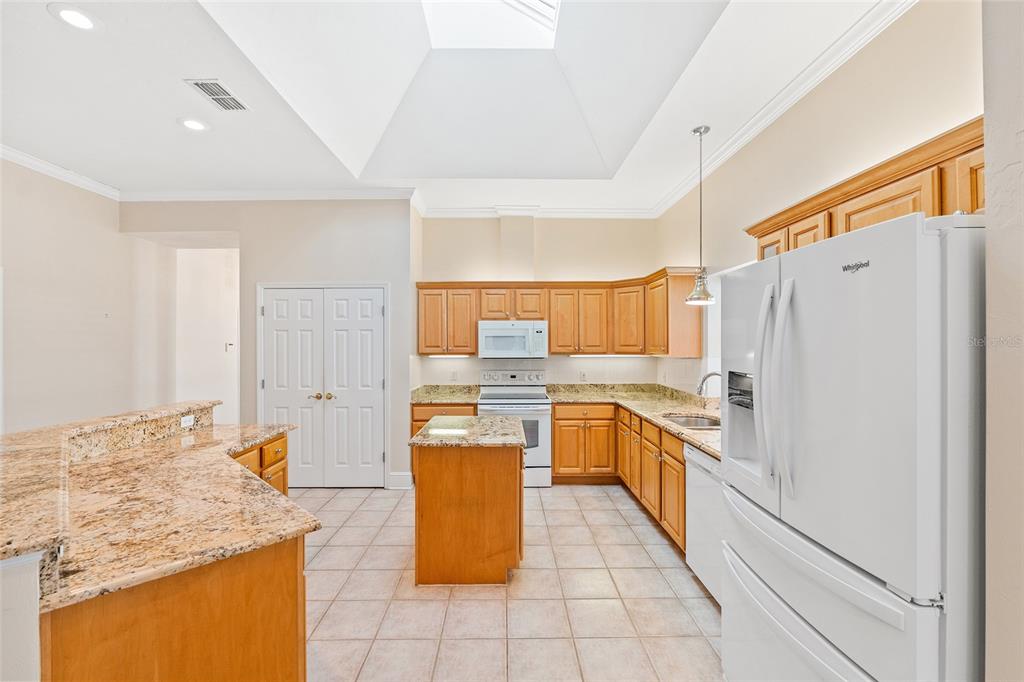 10526 Northwest 32nd Road Gainesville, FL 32606 - Photo 15 of 48 a kitchen with granite countertop cabinets and refrigerator