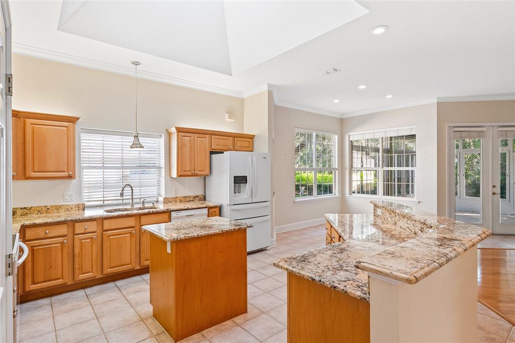 10526 Northwest 32nd Road Gainesville, FL 32606 - Photo 16 of 48 a kitchen with granite countertop sink stove and cabinets