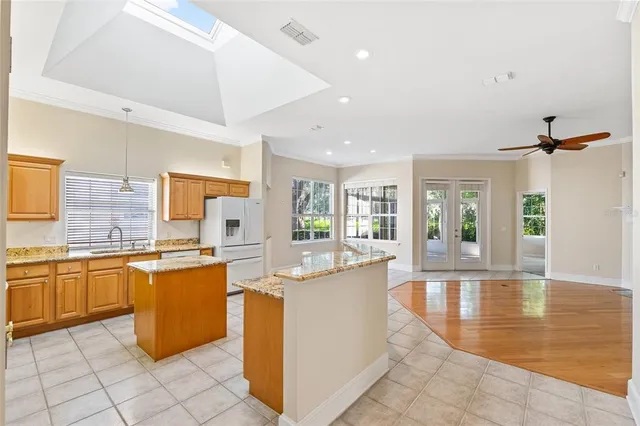 a large kitchen with kitchen island a sink counter top space and appliances