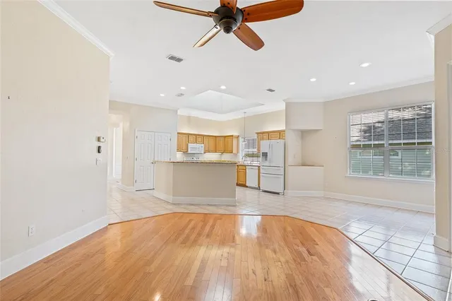 a view of empty room with wooden floor and window