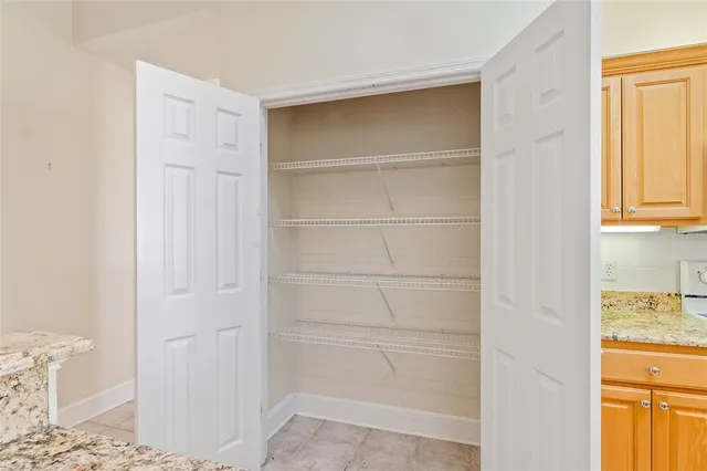 a view of walk in closet with empty racks