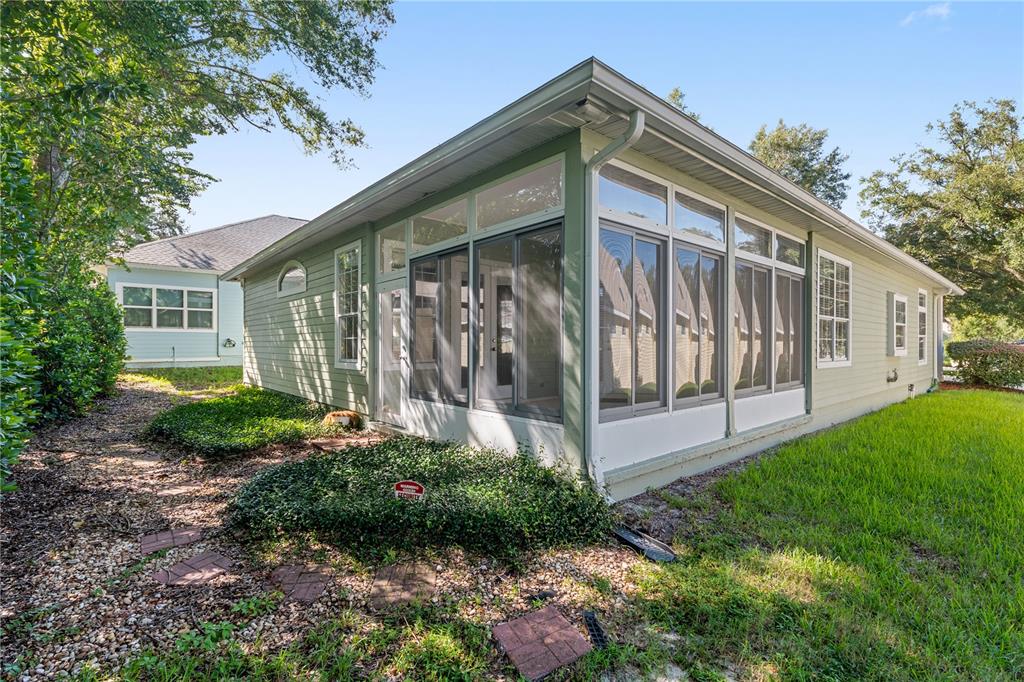10526 Northwest 32nd Road Gainesville, FL 32606 - Photo 39 of 48 a front view of a house with a yard and potted plants