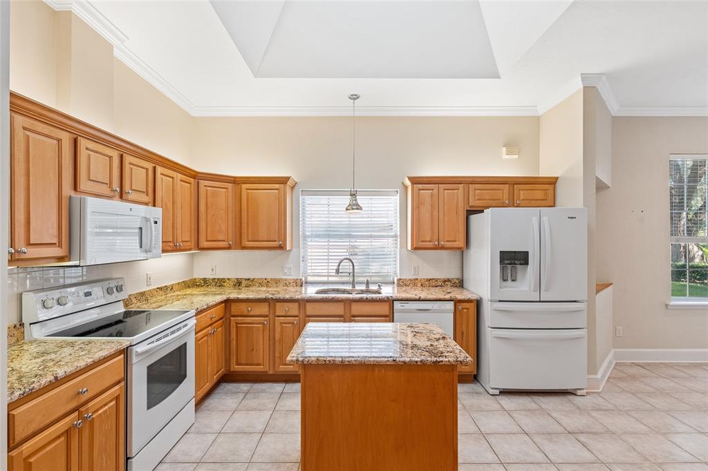 10526 Northwest 32nd Road Gainesville, FL 32606 - Photo 4 of 48 a kitchen with a stove top oven and cabinets