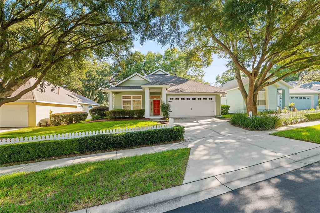 10526 Northwest 32nd Road Gainesville, FL 32606 - Photo 43 of 48 a front view of a house with a garden and trees