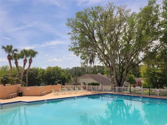 a view of a tennis court next to a yard