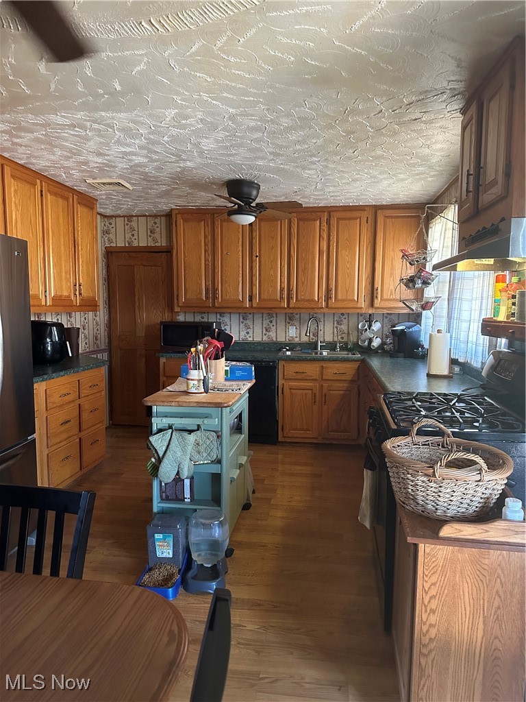 167 Andover Road Woodsfield, OH 43793 - Photo 19 of 50 Kitchen with Amish oak cabinetry, refrigerator, range, and a sink