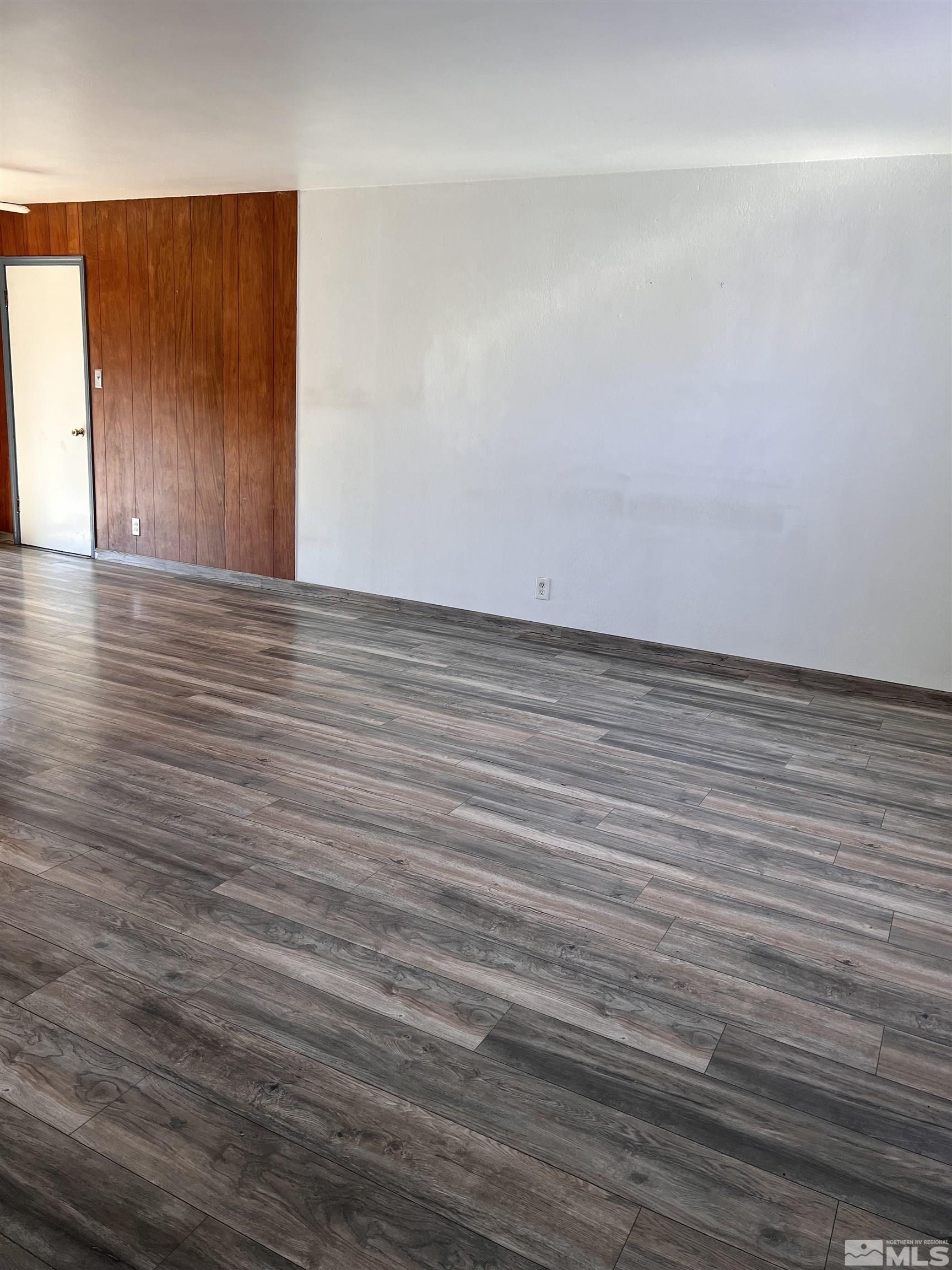 1425 Keystone Avenue Reno, NV 89503 - Photo 3 of 12 a view of an empty room with wooden floor and a window