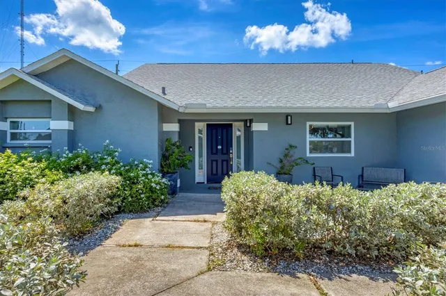 a view of a house with a flower garden