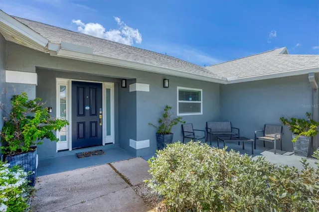 a view of an chairs and table in a patio
