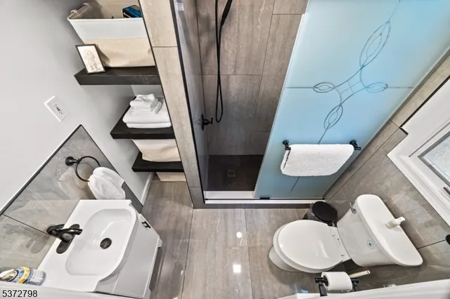 a bathroom with a sink mirror and toilet