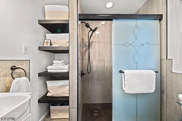a bathroom with a shower sink and toilet