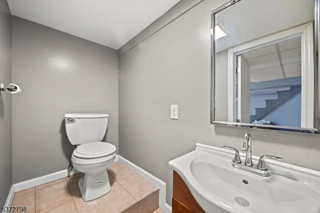 a bathroom with a sink toilet and a mirror