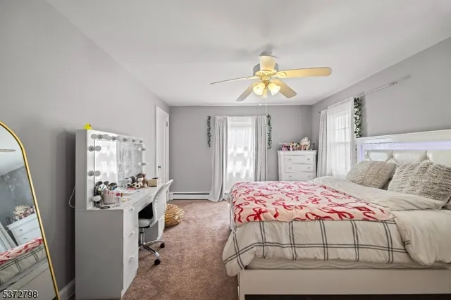 a bedroom with a bed dresser and window