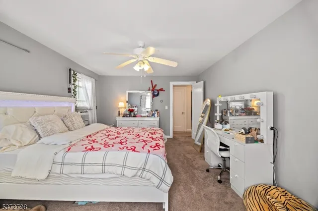 a bedroom with a bed flat screen tv and couches