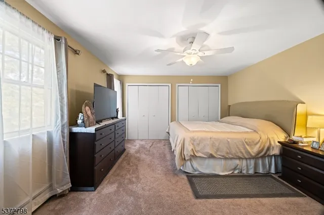 a bedroom with a bed and a television