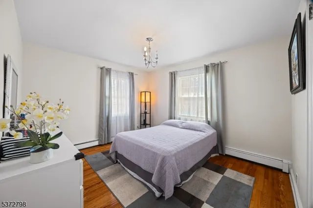 a spacious bedroom with a large bed and a chandelier