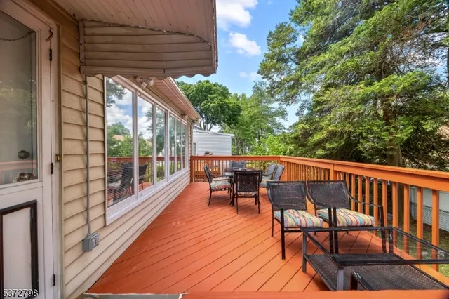 a view of a patio with table and chairs and wooden floor