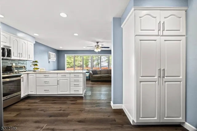 a kitchen with white cabinets and white appliances