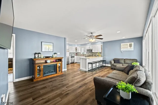 a living room with furniture and a kitchen