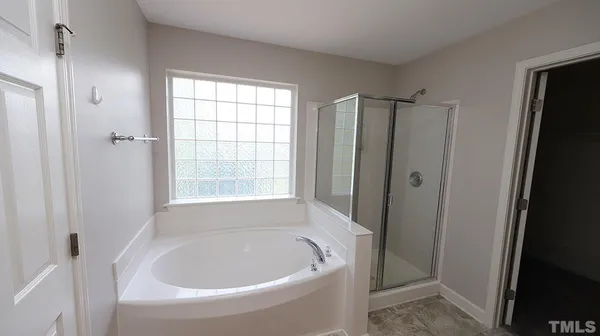 a white bath tub sitting in a bathroom