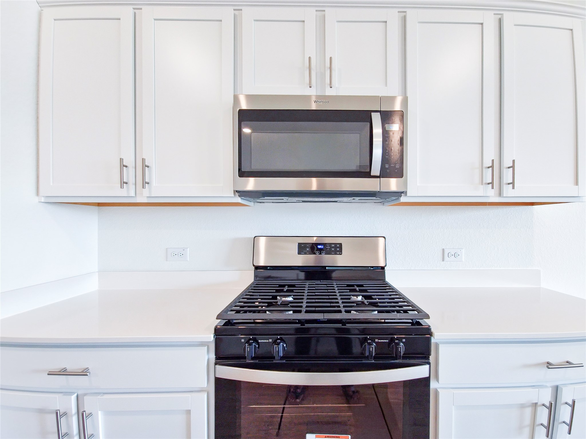 2313 March Hare Trace Leander, TX 78641 - Photo 12 of 30 Kitchen featuring stainless steel appliances, white cabinets, and light stone counters
