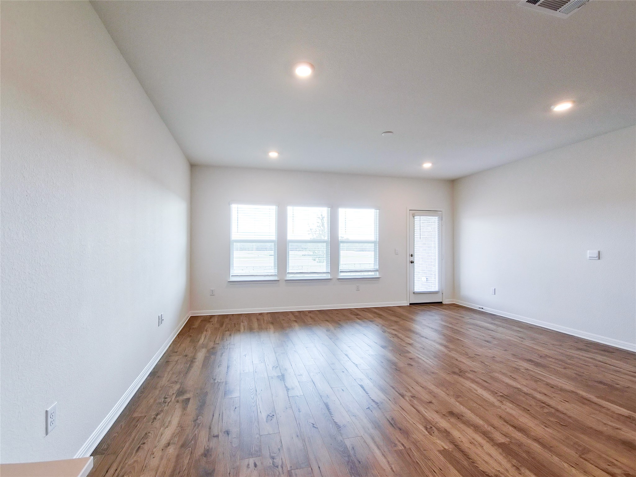 2313 March Hare Trace Leander, TX 78641 - Photo 22 of 30 Spare room featuring dark wood-style flooring and recessed lighting