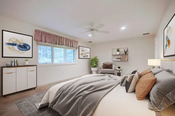 a bedroom with a large bed and a chandelier