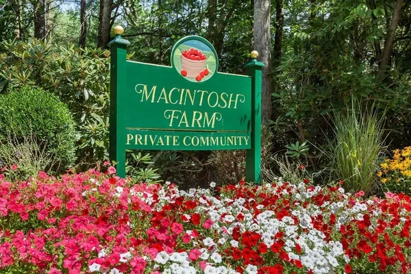 a sign that is in front of flowers