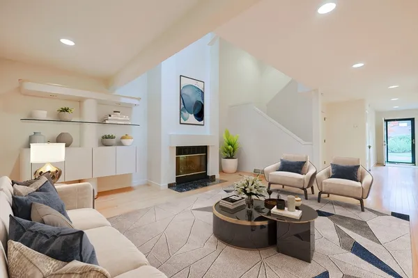 a living room with furniture fireplace and a mirror