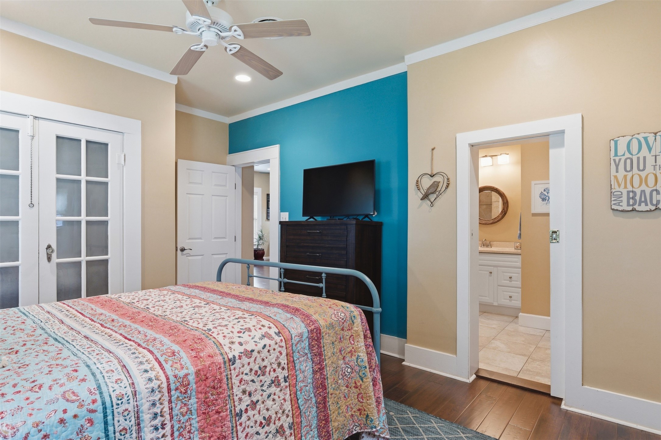 1726 13th Street Hempstead, TX 77445 - Photo 17 of 40 a bedroom with a bed and a flat tv screen on dresser