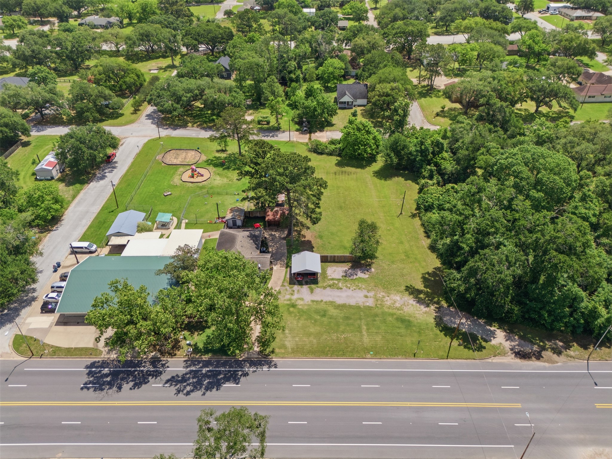 1726 13th Street Hempstead, TX 77445 - Photo 29 of 40 an aerial view of a house with a yard and lake view