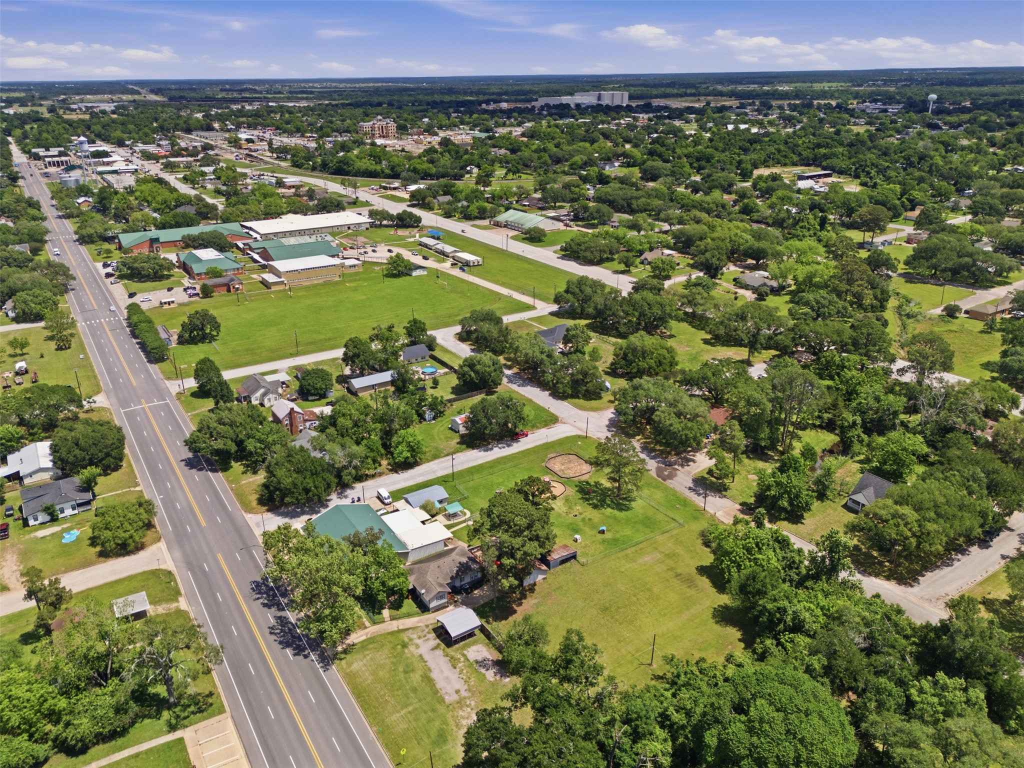 1726 13th Street Hempstead, TX 77445 - Photo 33 of 40 a view of a lush green field with lots of plants and trees in the background