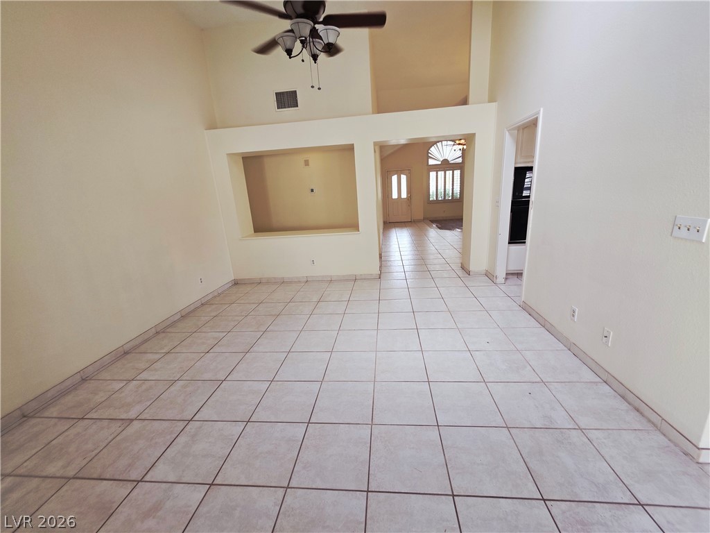 2920 Setting Sun Street Las Vegas, NV 89117 - Photo 20 of 43 This airy living space features soaring ceilings and durable tile flooring, creating an inviting atmosphere.