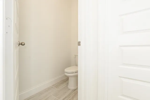 a kitchen with stainless steel appliances a refrigerator sink and white cabinets